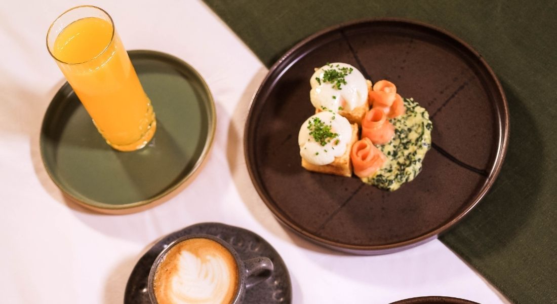 A plate of gourmet food in bed.